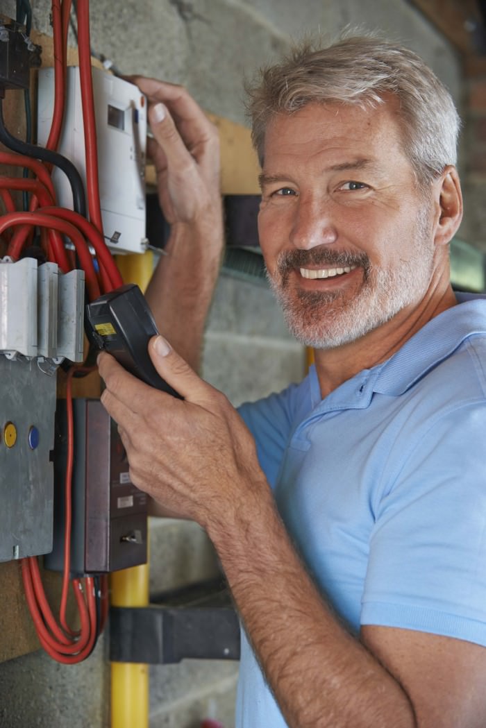 Portrait Of Man Taking Electricity Meter Reading